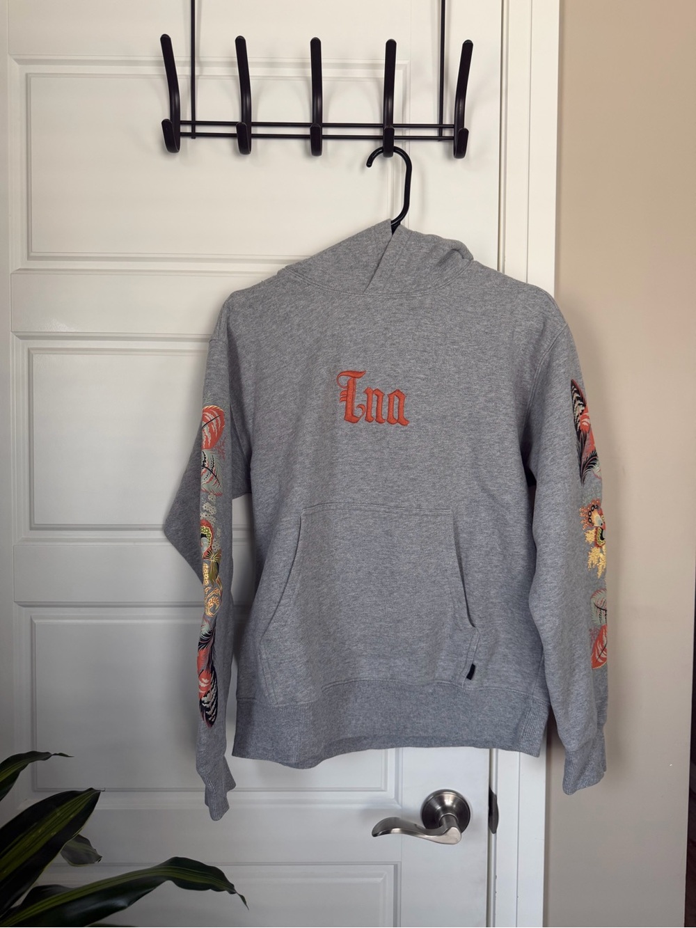 TNA Gray Crewneck Hoodie with Orange Script Logo and Floral Sleeve Embroidery